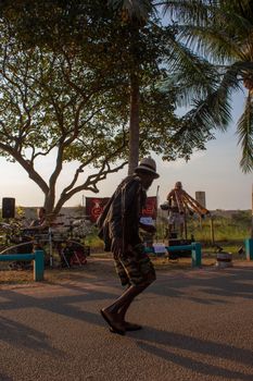 aborigine man is dancing to mordern didgeridoo music, on the beach market in darwin