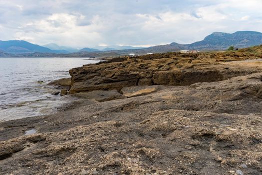Seascape with a rocky shore line under a blue sky. beauty of nature
