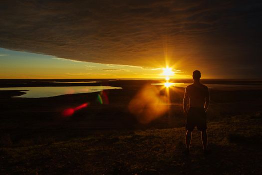 jung man enjoying beautiful sunset in the australian outback with 3 lakes, Gladstone scenic lookout