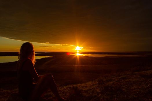 jung women enjoying beautiful sunset in the australian outback with 3 lakes, Gladstone scenic lookout