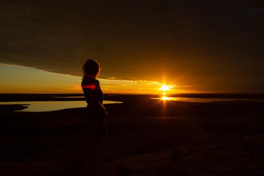 jung women enjoying beautiful sunset in the australian outback with 3 lakes, Gladstone scenic lookout