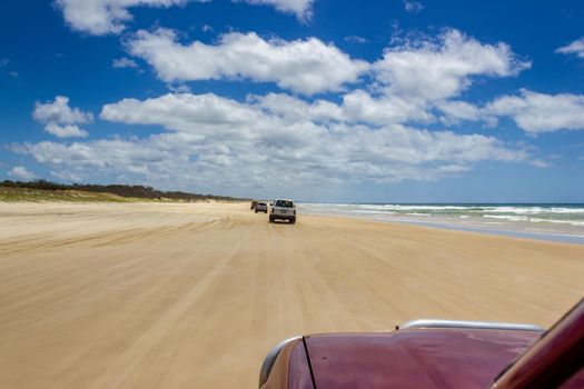 Main transportation highway on Fraser Island - wide wet sand beach coast facing Pacific ocean - long 75 miles beach.