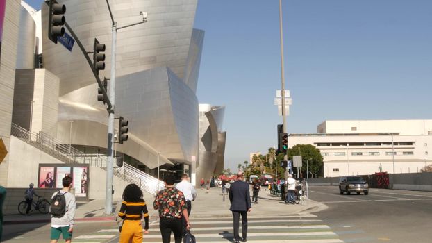 LOS ANGELES, CALIFORNIA, USA - 30 OCT 2019: People walking in metropolis, pedestrians on walkway in urban downtown. Citizens on street in financial district. City dwellers in LA among skyscrapers.