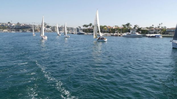 NEWPORT BEACH, CALIFORNIA, USA - 03 NOV 2019: Marina resort with yachts and sailboats, Pacific coast near Los Angeles. Regatta of nautical vessels, sail boat in harbor. Luxury suburb in Orange County.