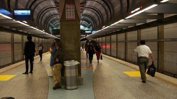 LOS ANGELES, CALIFORNIA, USA - 7 NOV 2019: Metro Rail transportation system. Metropolitan public passenger railway transport infrastructure. Citizens inside underground subway. People in LA City.