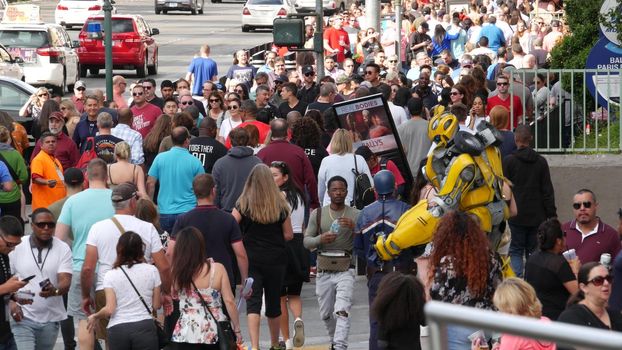 LAS VEGAS, NEVADA USA - 7 MAR 2020: People on pedestrian walkway. Multicultural men and women walking on city promenade. Crowd of citizens on sidewalk. Diversity of multiracial faces in metropolis.