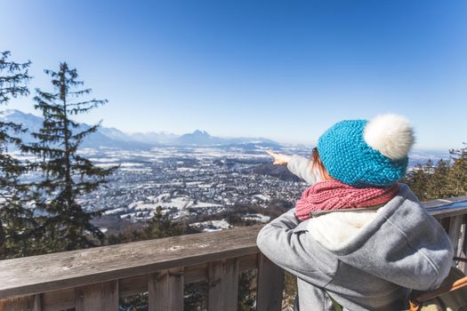 Back of young woman enjoying the view over the mountains, outlook. Gaisberg, Austria