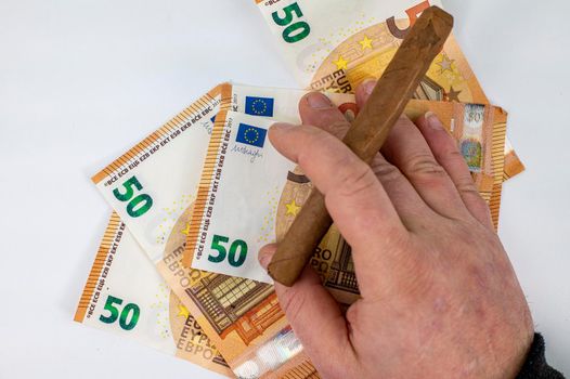 50 euro bills with man hand holding cigar on white background