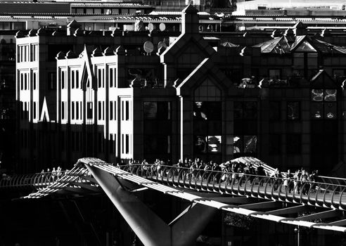 LONDON, UK - CIRCA JUNE 2011: Black and white shot of the Millennium Bridge. The Millennium Bridge is a steel suspension bridge over the Thames River for pedestrians.