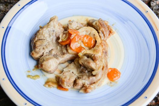 homemade marrowbone with the grandmother's recipe of carrots, celery, tomatoes and slow cooking