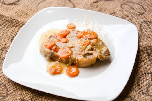 homemade marrowbone with the grandmother's recipe of carrots, celery, tomatoes and slow cooking