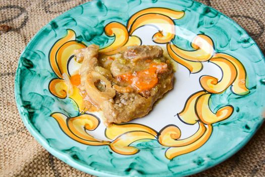 homemade marrowbone with the grandmother's recipe of carrots, celery, tomatoes and slow cooking