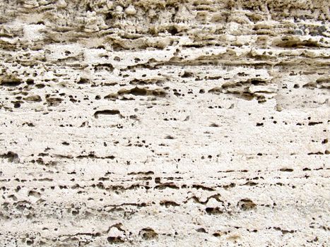 Outdoor porous stone surface in white color detailed close-up texture.Texture or background