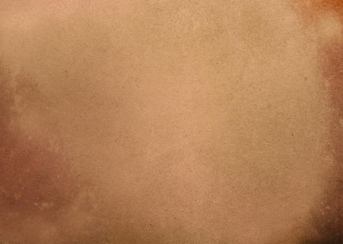 A rough old brown paper background with dark edges on the sides.Texture or background