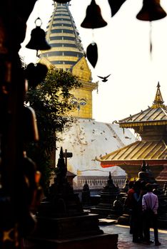 Swayambhunath stupa in Kathmandu, Nepal. Bells silhouette in the foreground.