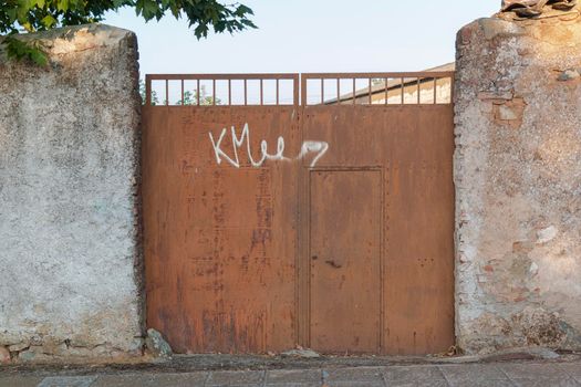 Beautiful couples, fields and landscapes of the Cordoba mountains in Spain. Photograph taken in the month of July. Rusty door with gratitti