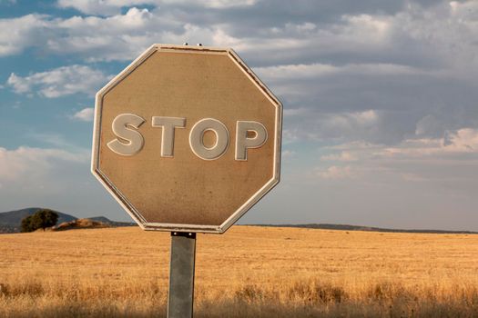 Beautiful couples, fields and landscapes of the Cordoba mountains in Spain. Photograph taken in the month of July. Faded stop sign