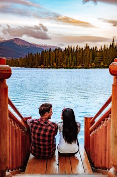 Beauvert lake at Jasper, Canada, Canadian lake popular for canoe. in the Canadian Rockies Jasper national park, couple men and woman mid age looking out over the lake