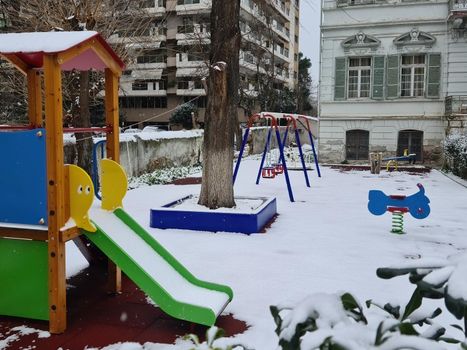 Day view of a recreation area without children or crowd, on a white frozen ground.