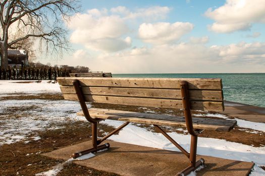 a bench overlooking lake ontario in the community of Niagara on the Lake . High quality photo