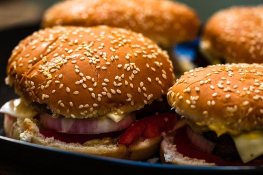 Closeup of fresh homemade tasty burgers on wooden table