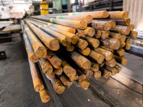 rusted long round steel bars pack - close-up with selective focus and background blur