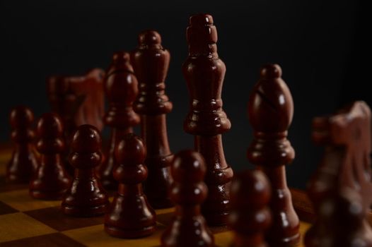 A closeup of the pieces to a game of chess beginning to be played.
