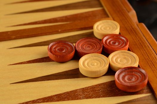 A closeup of a game of backgammon in play.