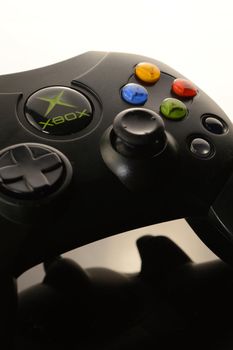 SMITHS FALLS, ONTARIO, CANADA: JANUARY 23, 2021 - An Xbox video game controller over a black and white reflective background.