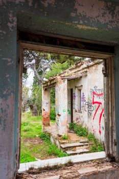 Villa Levidi, Pallini, Greece - February 14, 2021: Window view of an abandoned old villa at Pallini, Greece