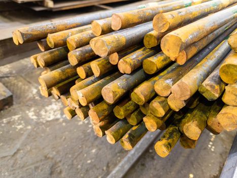 rusted long round steel bars pack - close-up with selective focus and background blur