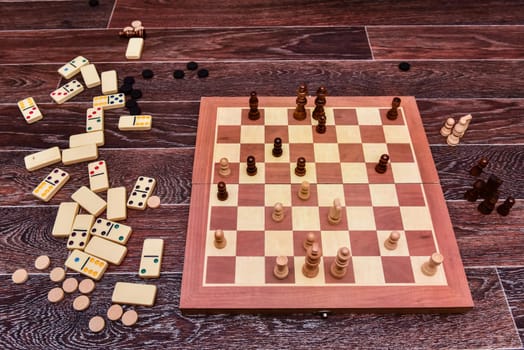 White and black chess pieces stand on board during a chess game. top view.