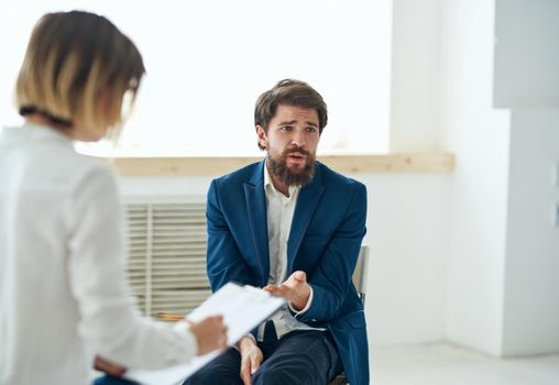 Emotional man at the reception of a psychologist consultation diagnosis . High quality photo