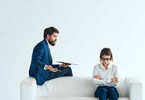 Work colleagues sit on the couch communicating lifestyle interior emotions. High quality photo