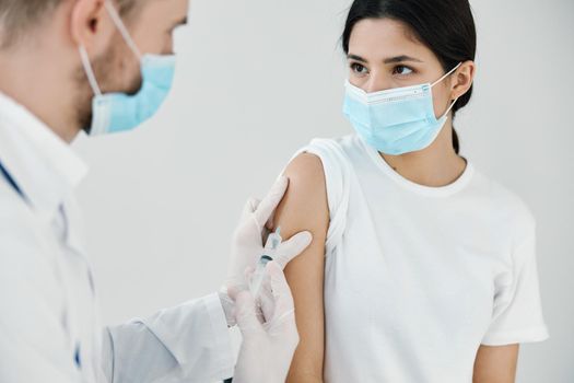 patient in medical mask in hospital and doctor vaccination injection. High quality photo