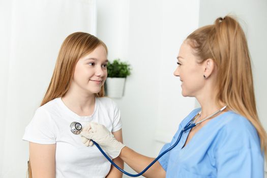 woman doctor examining a child hospital health treatment. High quality photo