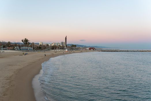 Barcelona, Spain - Febrary, 2021 - Sunset in Nova Icaria Beach in the Barcelona area on the Mediterranean on winter 2021