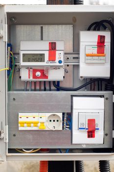 An introductory machine and an electric energy meter in a dashboard on a pole close-up