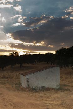 Water well of an old farm in the middle of the countryside of the Sierra of Cordoba Andalusia at sunset