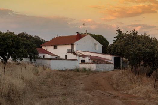 Farm in the middle of the countryside of the Sierra of cordoba Andalusia at sunset