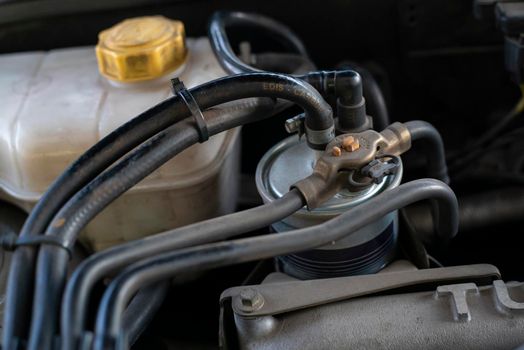 Detail of the diesel filter inside the engine compartment of a car