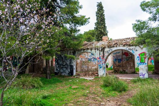 Villa Levidi, Pallini, Greece - February 14, 2021: Abstract face wall painting at an abandoned old villa at Pallini, Greece