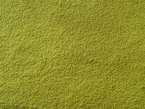 Powdered matcha green tea background. Close up. Dry green maccha powder tea with copy space for text or design