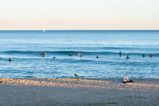 Barcelona, Spain: 2021 February 12: People surfing in the Barcelona beach in time of Covid 19 in winter 2021.