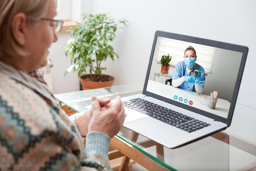 Young female doctor consulting with elderly woman over video help line virtual medical appointment,GP prescribing medication to senior patient, telemedicine diagnosis, therapy and treatment concept