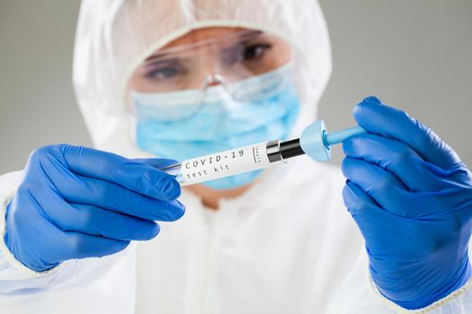 Medical technologist inspecting quick antigen test kit,COVID-19 virus disease rapid rt-PCR DNA enzyme analysis,Coronavirus global pandemic outbreak,patient antibodies testing procedure,clinical trial