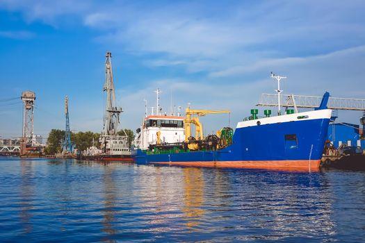 Kaliningrad , Russia. Port of a large Russian city with ships and various equipment on the background of the river.