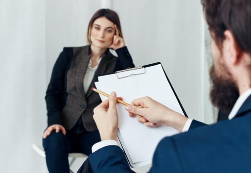 Woman for job interview and man with documents in the foreground. High quality photo