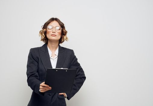 Woman with a folder of documents in her hands on a light background Copy Space. High quality photo