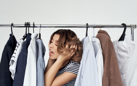 Woman in fitting room with clothes in hand shopping shirt. High quality photo